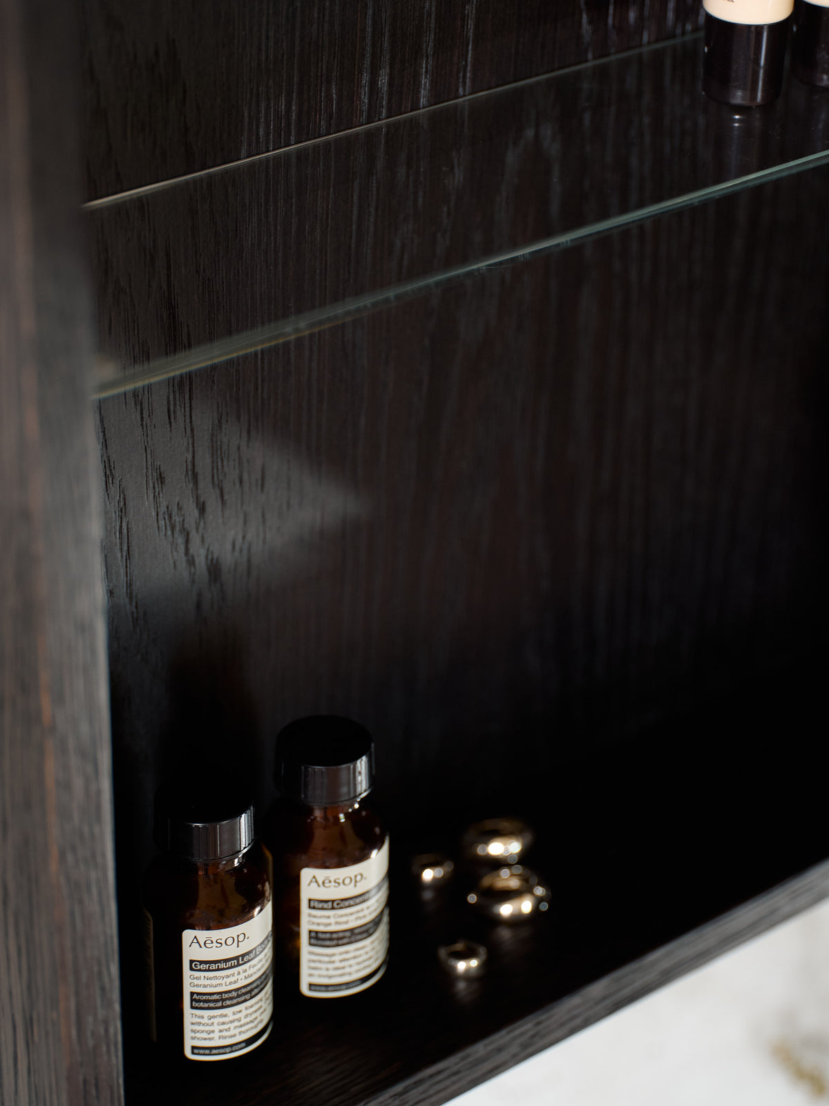 Dark oak bathroom mirror cabinet interior with adjustable glass shelf